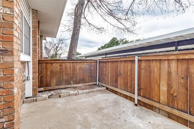 a view of a backyard with wooden fence