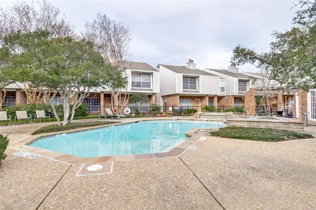 a view of a white house with a swimming pool