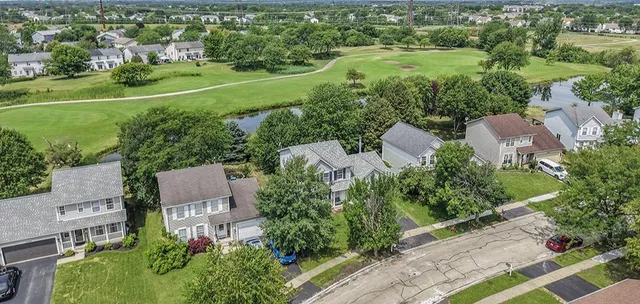 an aerial view of a house with outdoor space and street view