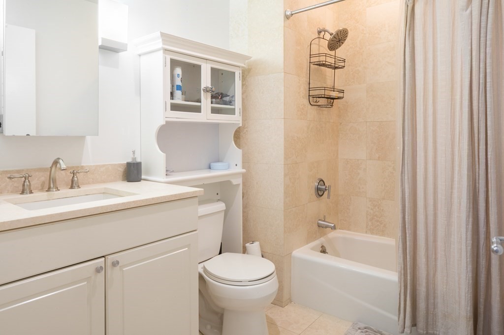 80 Broad Street, Unit 403 Boston, MA 02110 - Photo 7 of 16 a bathroom with a sink toilet and shower