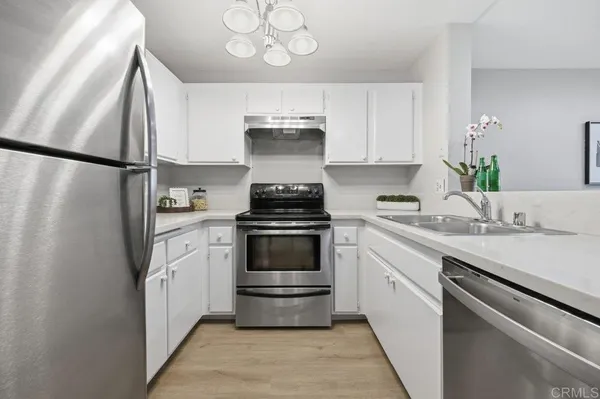a kitchen with a sink and a stove top oven