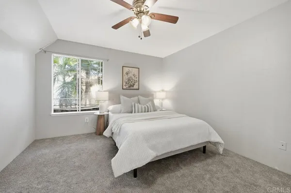 a bedroom with a bed and window