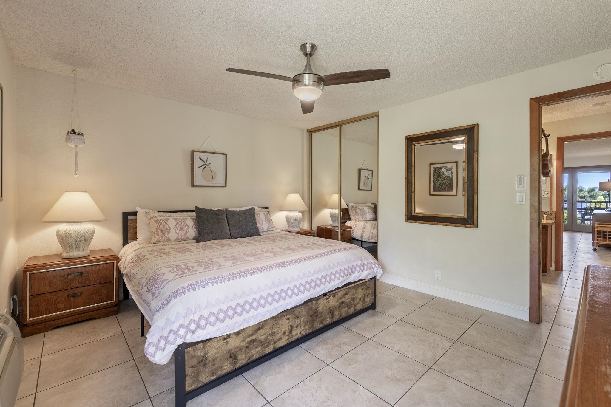 2881 South Kihei Road, Unit 59 Kihei, HI 96753 - Photo 16 of 37 a spacious bedroom with a bed and a lamp