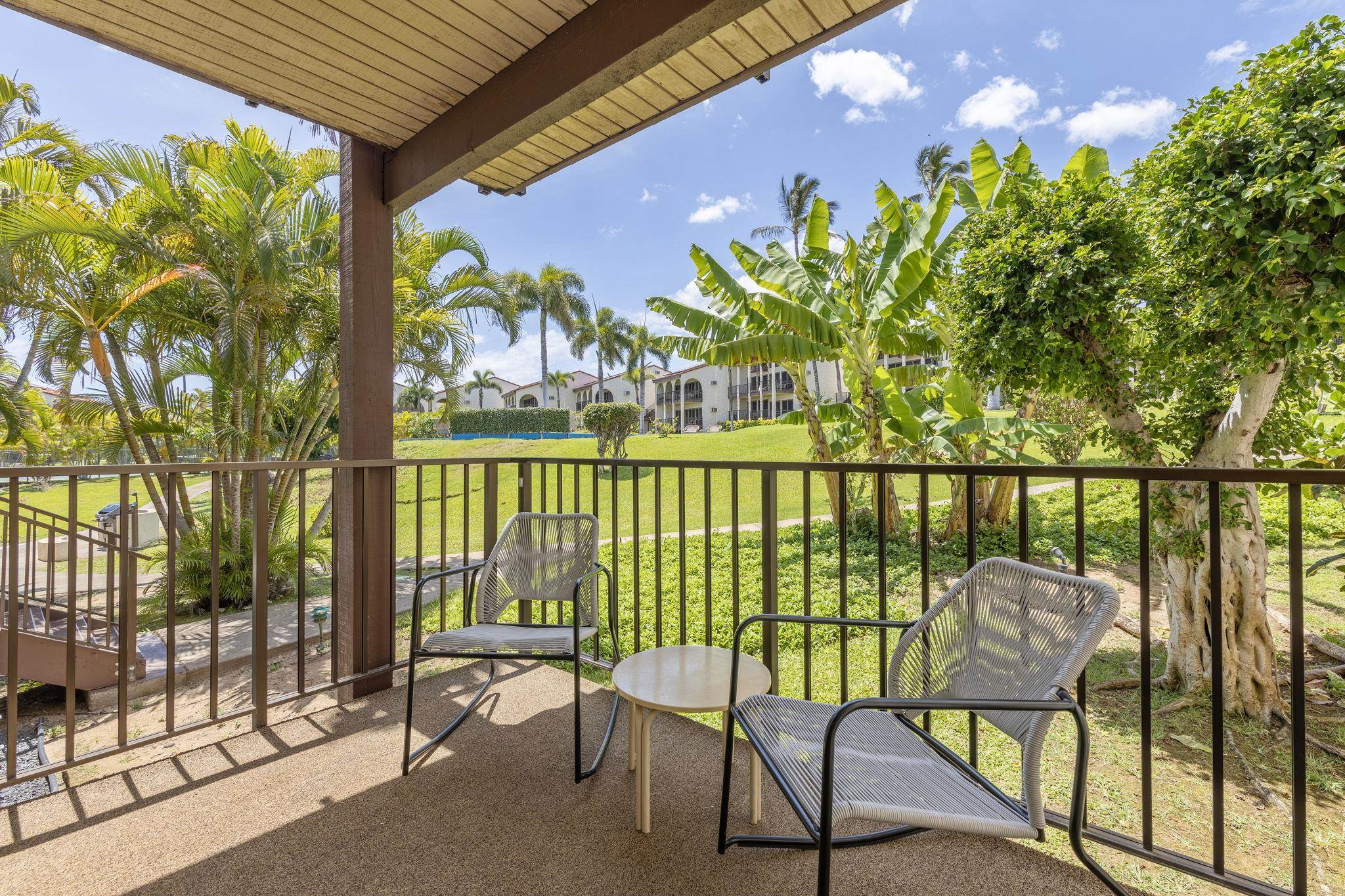2881 South Kihei Road, Unit 59 Kihei, HI 96753 - Photo 18 of 37 a view of a chairs and table in patio with wooden fence