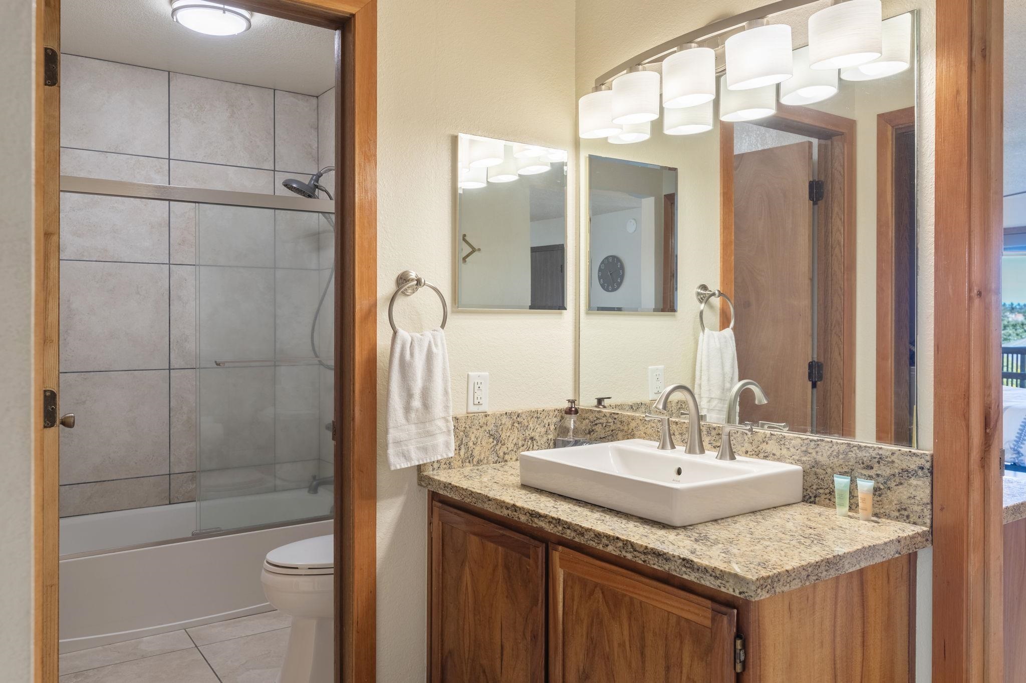2881 South Kihei Road, Unit 59 Kihei, HI 96753 - Photo 19 of 37 a bathroom with a granite countertop sink and a mirror