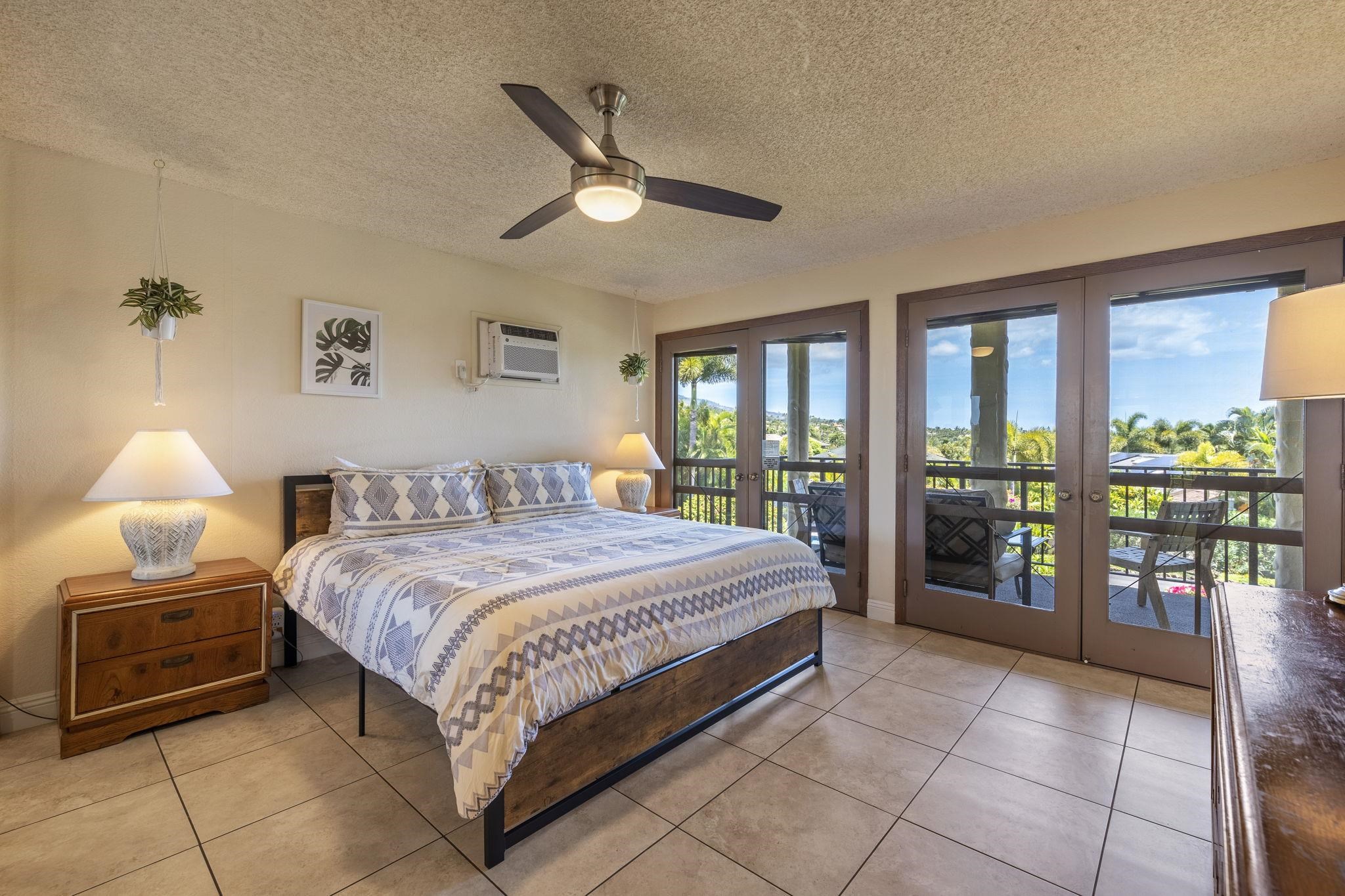 2881 South Kihei Road, Unit 59 Kihei, HI 96753 - Photo 22 of 37 a bedroom with a large bed and a chandelier