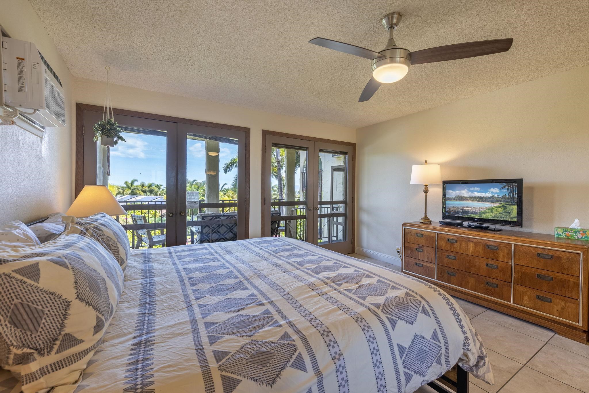 2881 South Kihei Road, Unit 59 Kihei, HI 96753 - Photo 23 of 37 a bedroom with a bed and a television