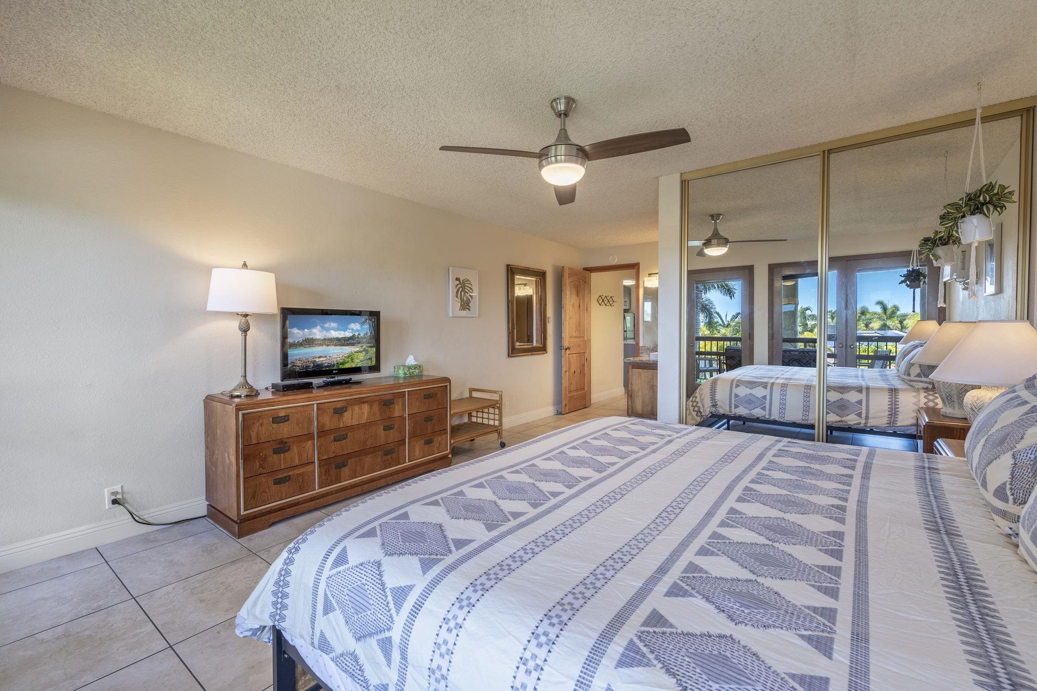2881 South Kihei Road, Unit 59 Kihei, HI 96753 - Photo 25 of 37 a bedroom with a bed and a television
