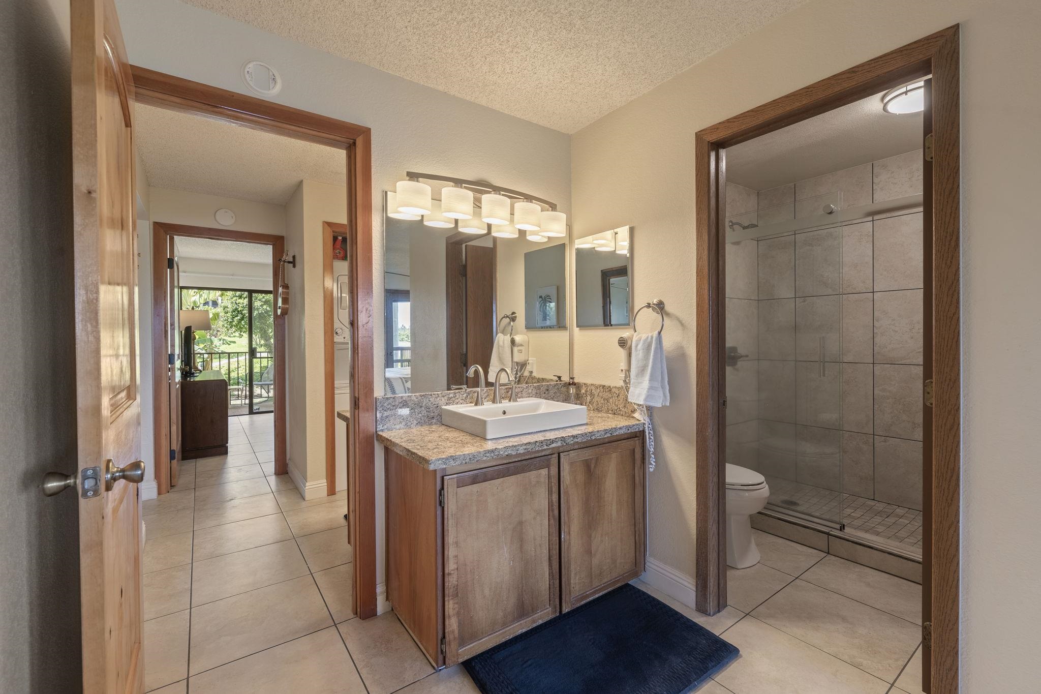 2881 South Kihei Road, Unit 59 Kihei, HI 96753 - Photo 26 of 37 a bathroom with a granite countertop sink a toilet and shower