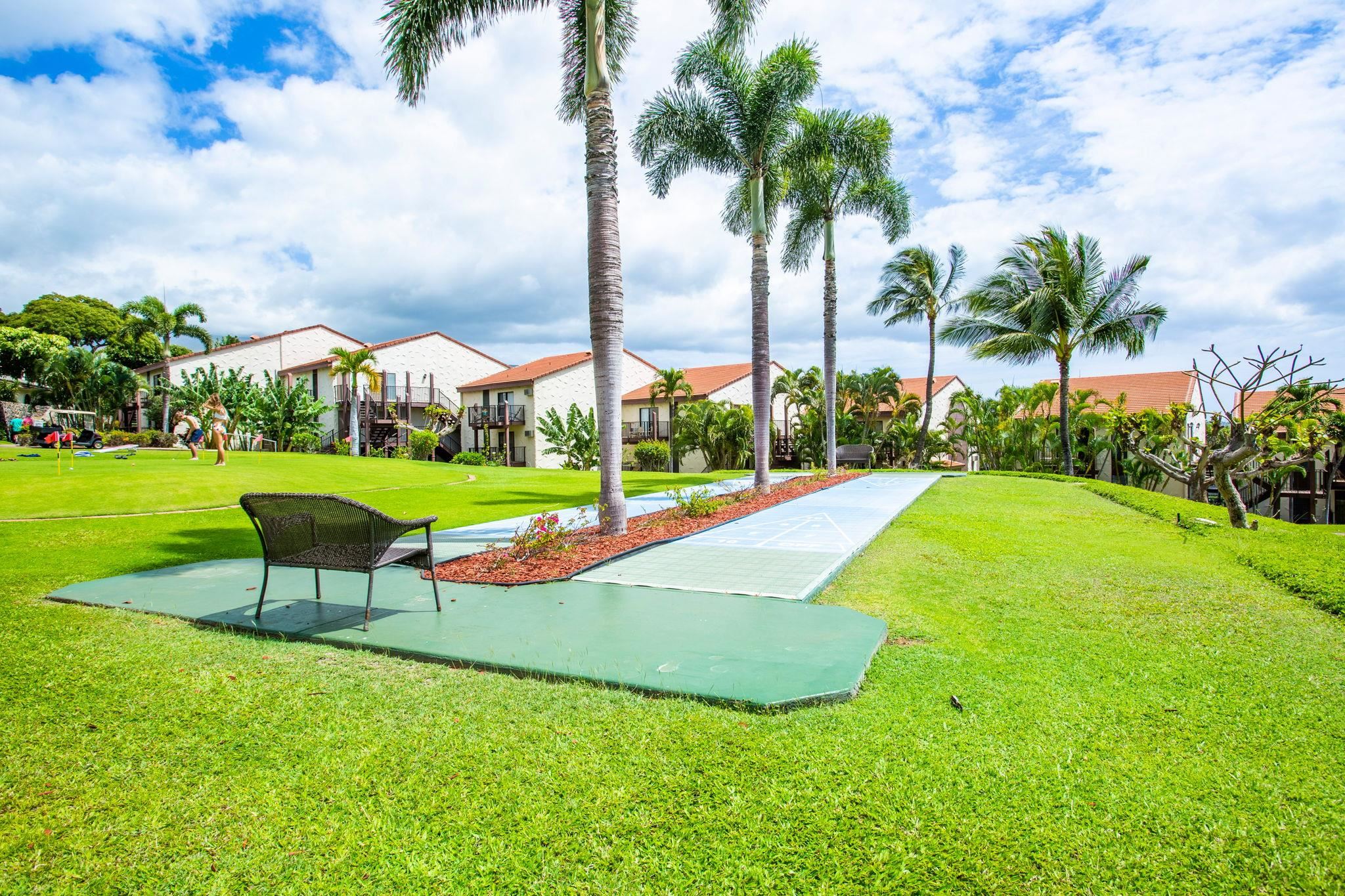 2881 South Kihei Road, Unit 59 Kihei, HI 96753 - Photo 31 of 37 a view of a garden with lawn chairs under an umbrella