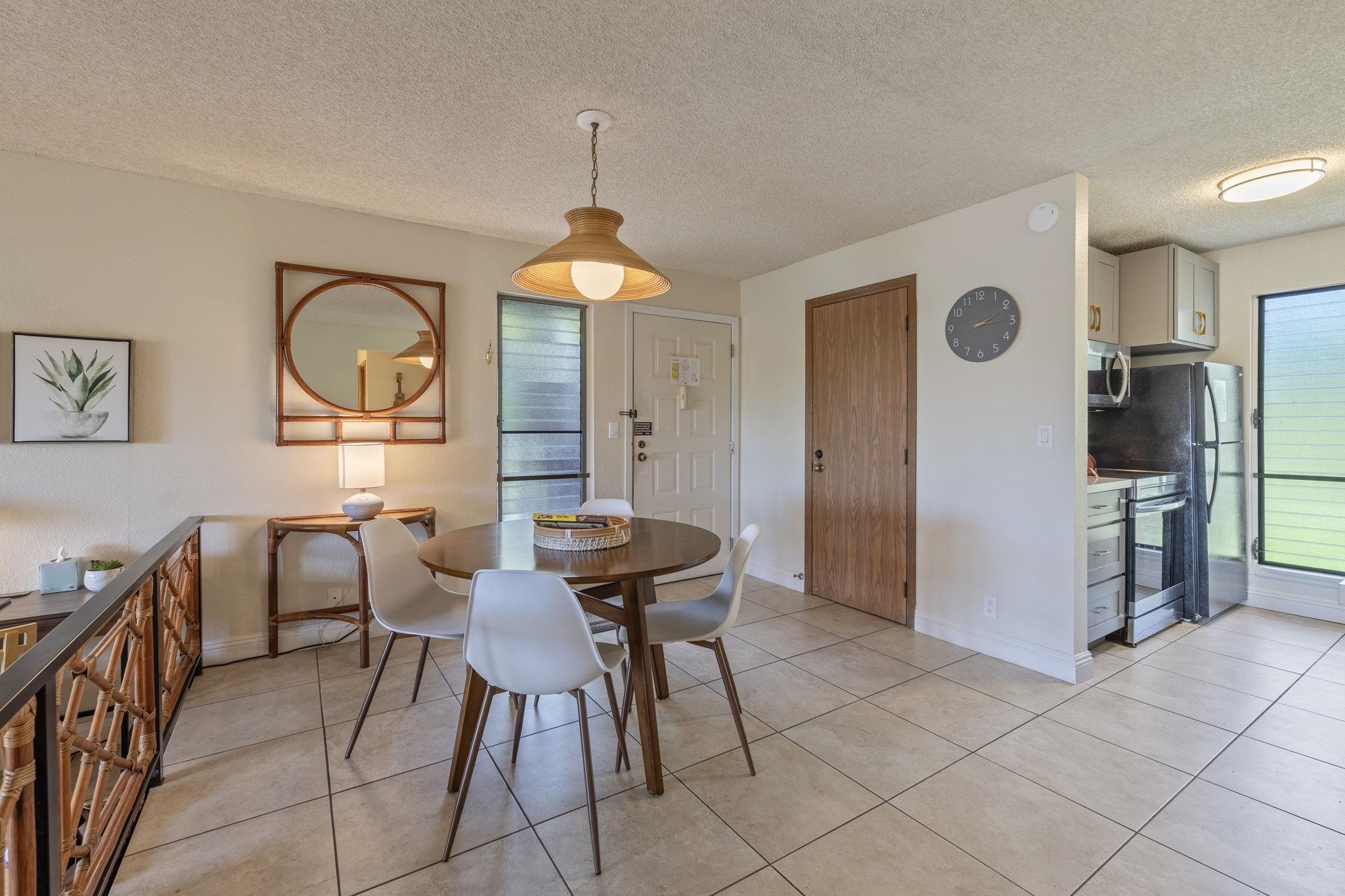 2881 South Kihei Road, Unit 59 Kihei, HI 96753 - Photo 7 of 37 a dining room with furniture and a chandelier