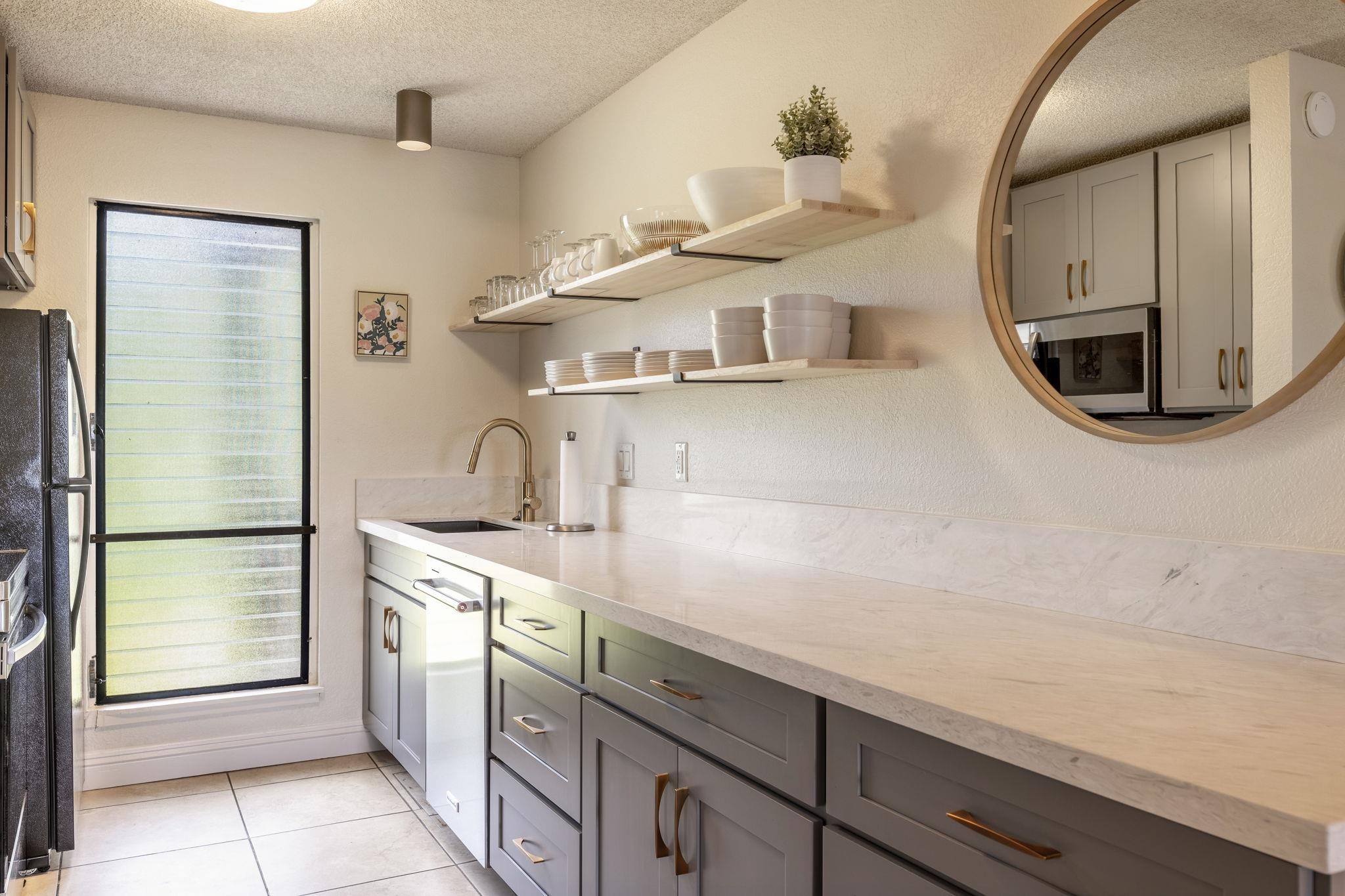 2881 South Kihei Road, Unit 59 Kihei, HI 96753 - Photo 8 of 37 a kitchen with stainless steel appliances a sink stove and a refrigerator