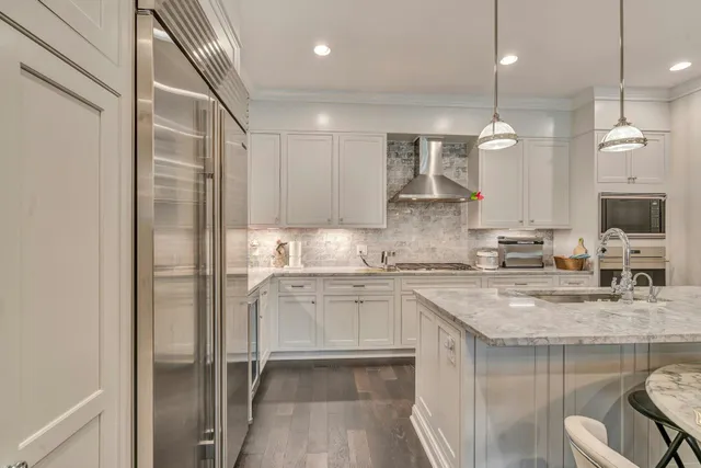 a kitchen with a sink stainless steel appliances and cabinets