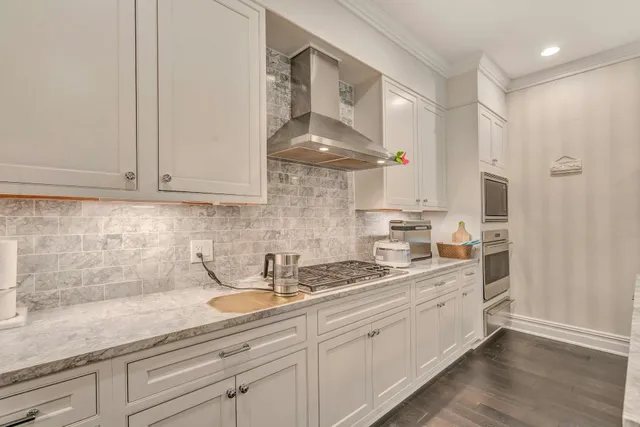 a kitchen with a sink dishwasher stove and cabinets