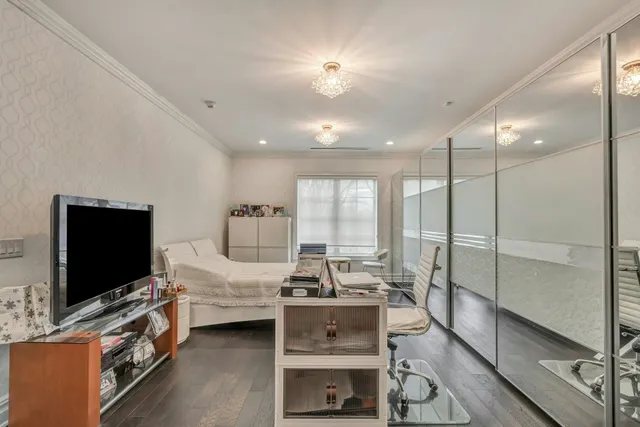 a bedroom with furniture and a flat screen tv