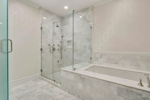 a bathroom with a shower and a tub
