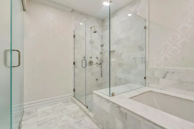 a bathroom with a bathtub and a shower