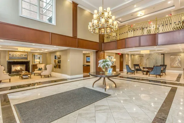 a view of a room with chandelier fan and view of living room