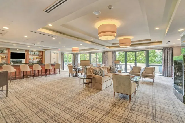 a living room with lots of chairs and a table