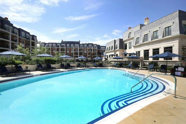 a swimming pool with outdoor seating and yard