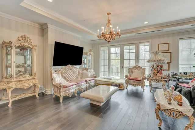 a living room with furniture or chandelier and a flat screen tv
