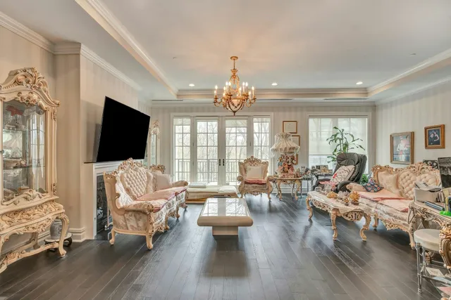 a living room with furniture flat screen tv and a large window