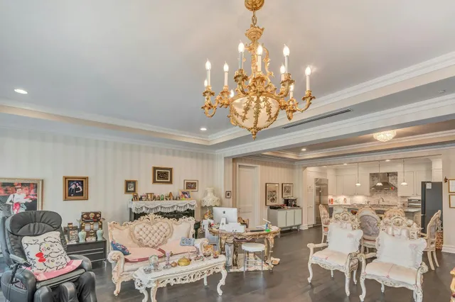 a view of a dining room with furniture a chandelier and wooden floor