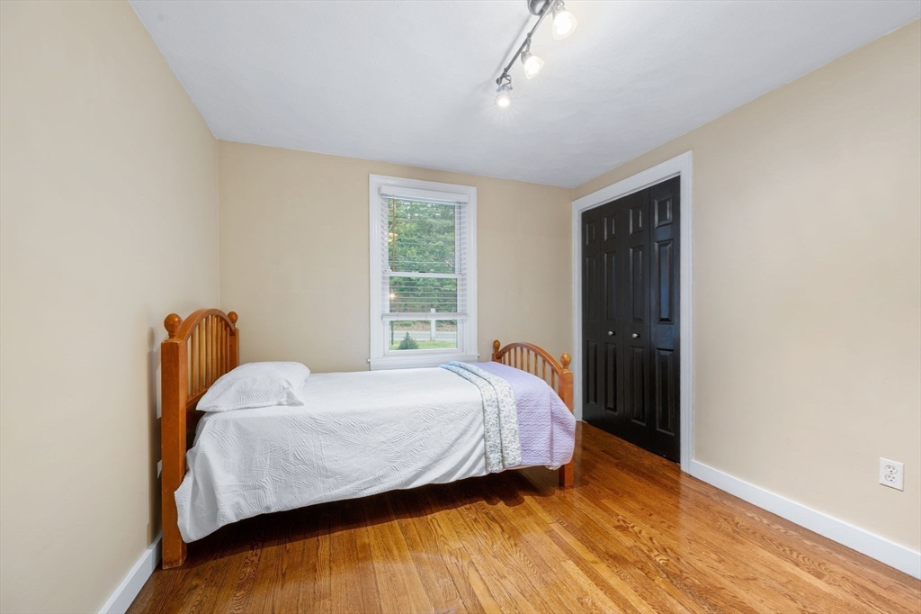 175 Central Street North Reading, MA 01864 - Photo 19 of 42 a bedroom with a bed and wooden floor