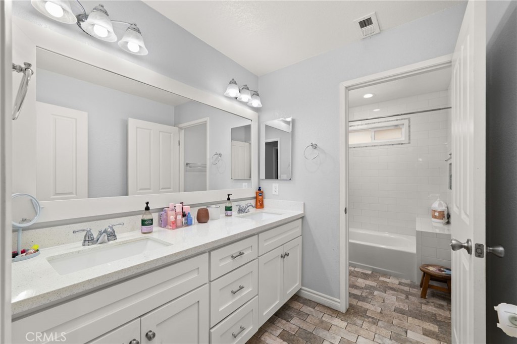 18165 Mariposa Avenue Riverside, CA 92508 - Photo 20 of 59 a bathroom with a double vanity sink mirror double and bathtub
