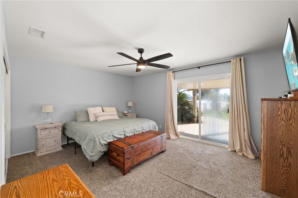 18165 Mariposa Avenue Riverside, CA 92508 - Photo 26 of 59 a bedroom with a bed painting and a large window