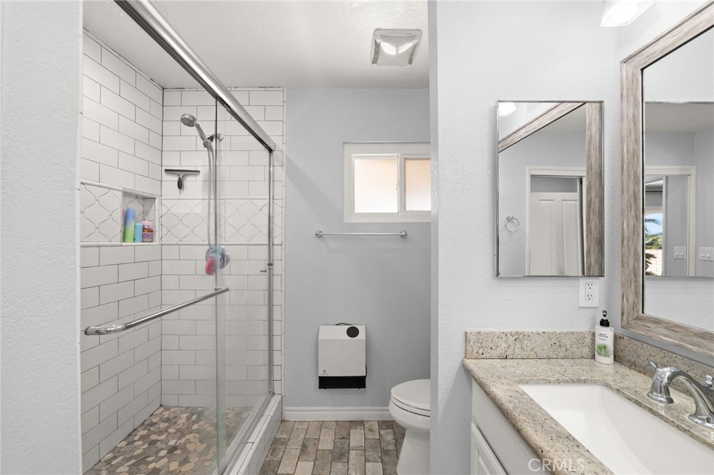 18165 Mariposa Avenue Riverside, CA 92508 - Photo 29 of 59 a bathroom with a granite countertop sink toilet and shower