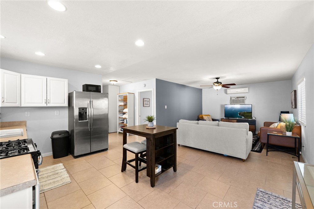 18165 Mariposa Avenue Riverside, CA 92508 - Photo 36 of 59 a living room with furniture a refrigerator and furniture