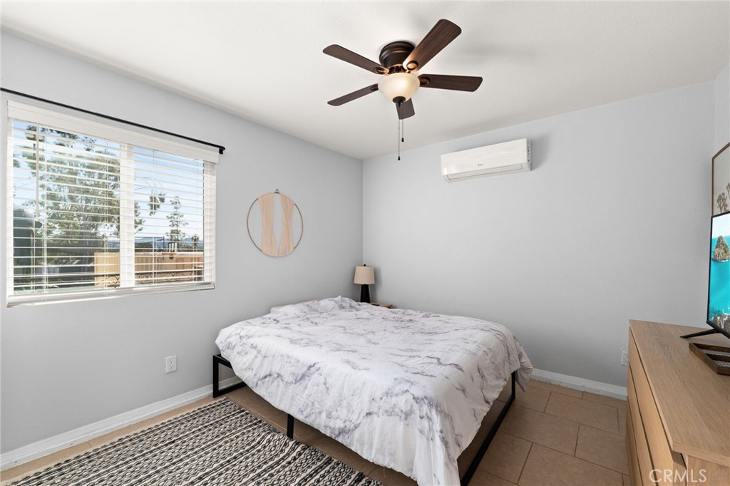 18165 Mariposa Avenue Riverside, CA 92508 - Photo 43 of 59 a bedroom with a large bed and a window