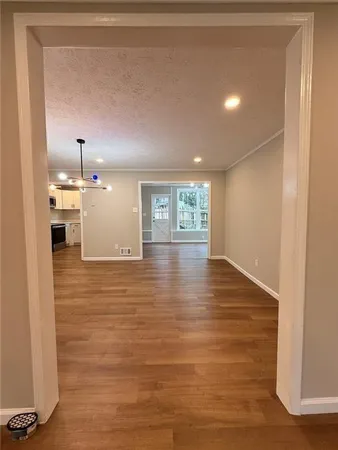 a view of a hallway with wooden floor and staircase