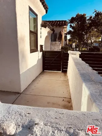 a view of a couches in the patio and a couple of cars parked in parking lot