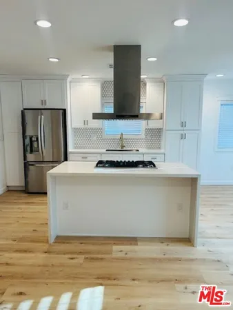 a view of kitchen refrigerator and microwave