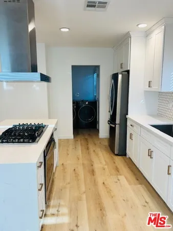 a kitchen with a sink stove and refrigerator