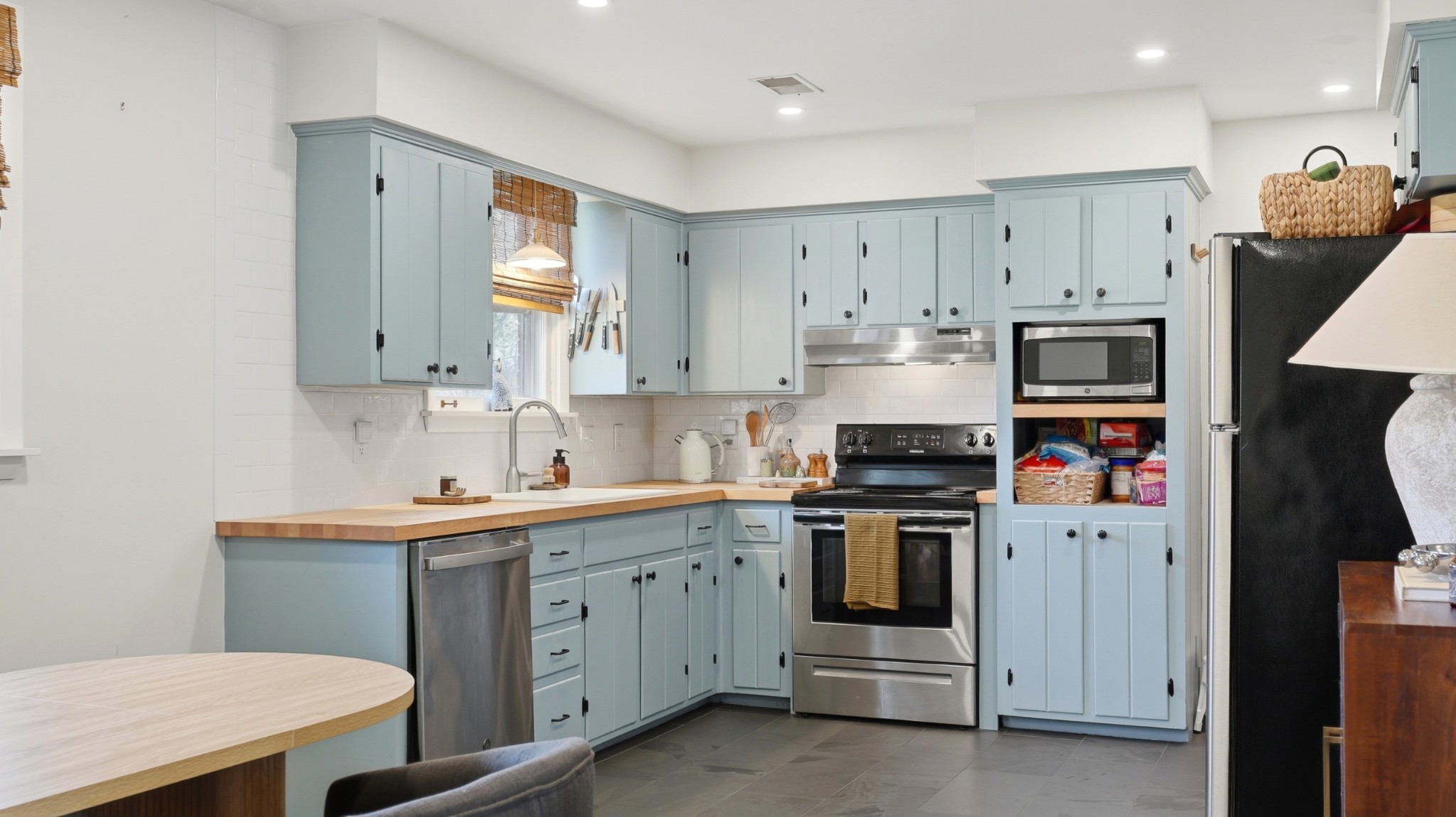 7524 Gary Road Joelton, TN 37080 - Photo 6 of 39 a kitchen with stainless steel appliances granite countertop a stove and white cabinets