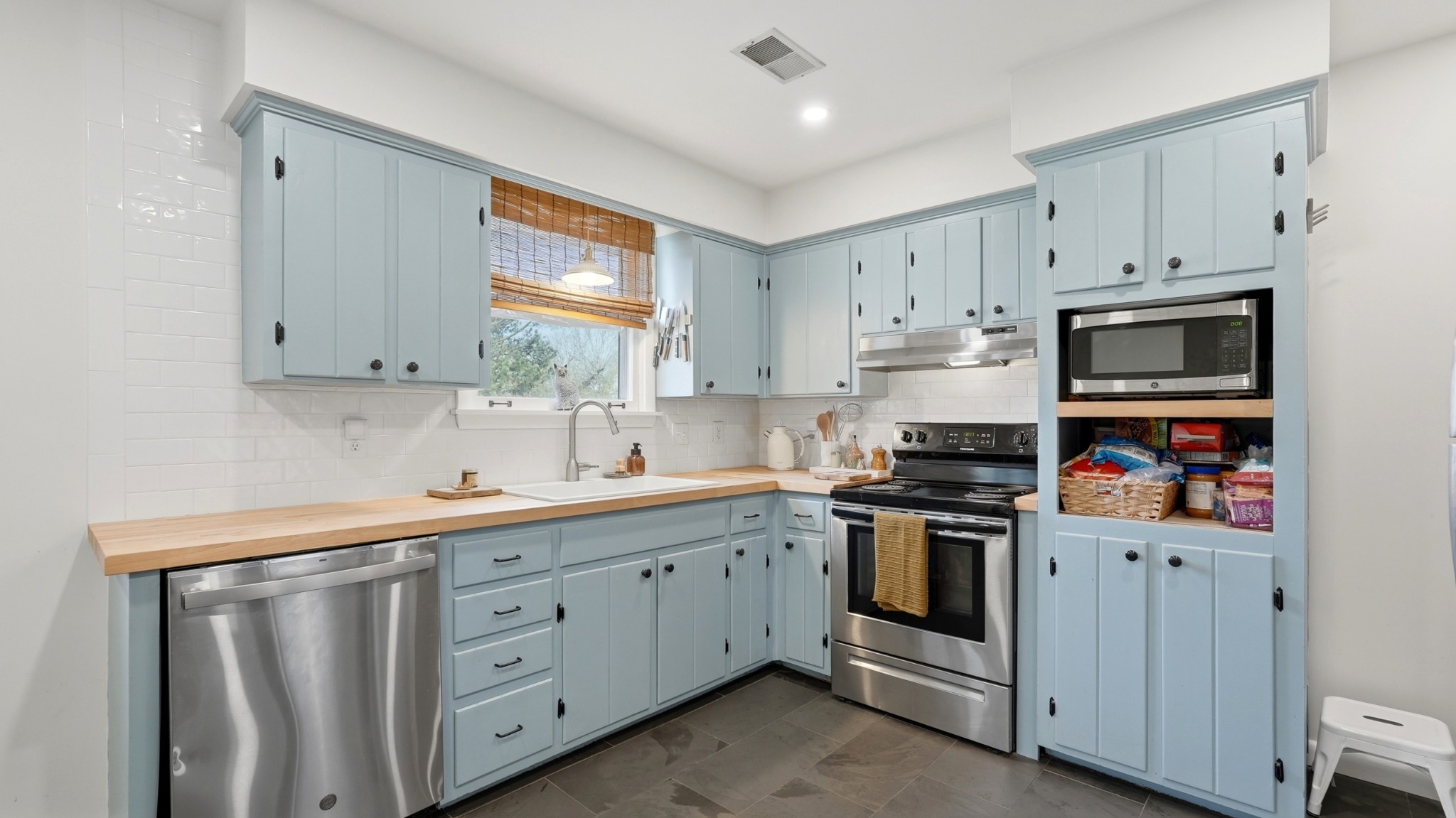 7524 Gary Road Joelton, TN 37080 - Photo 7 of 39 a kitchen with white cabinets stainless steel appliances and sink