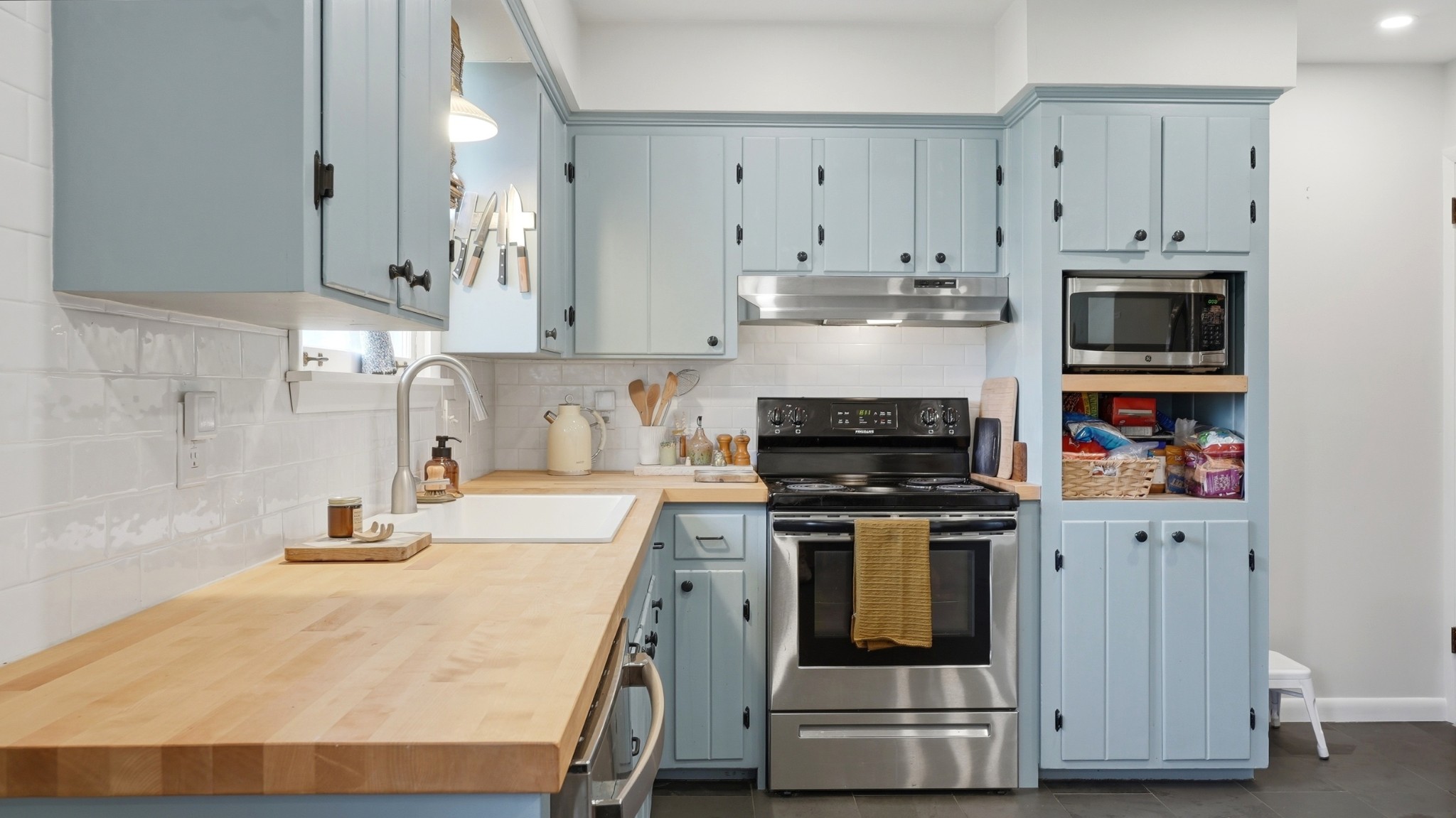 7524 Gary Road Joelton, TN 37080 - Photo 8 of 39 a kitchen with stainless steel appliances granite countertop a stove and white cabinets