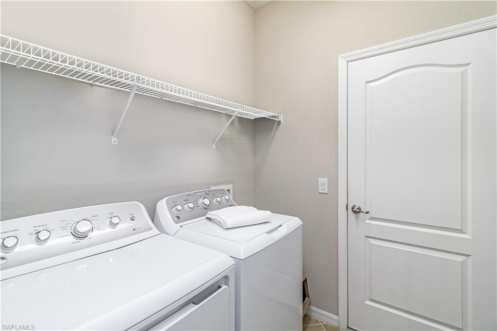 4272 Raffia Palm Circle Naples, FL 34119 - Photo 21 of 41 Clothes washing area with washer and clothes dryer