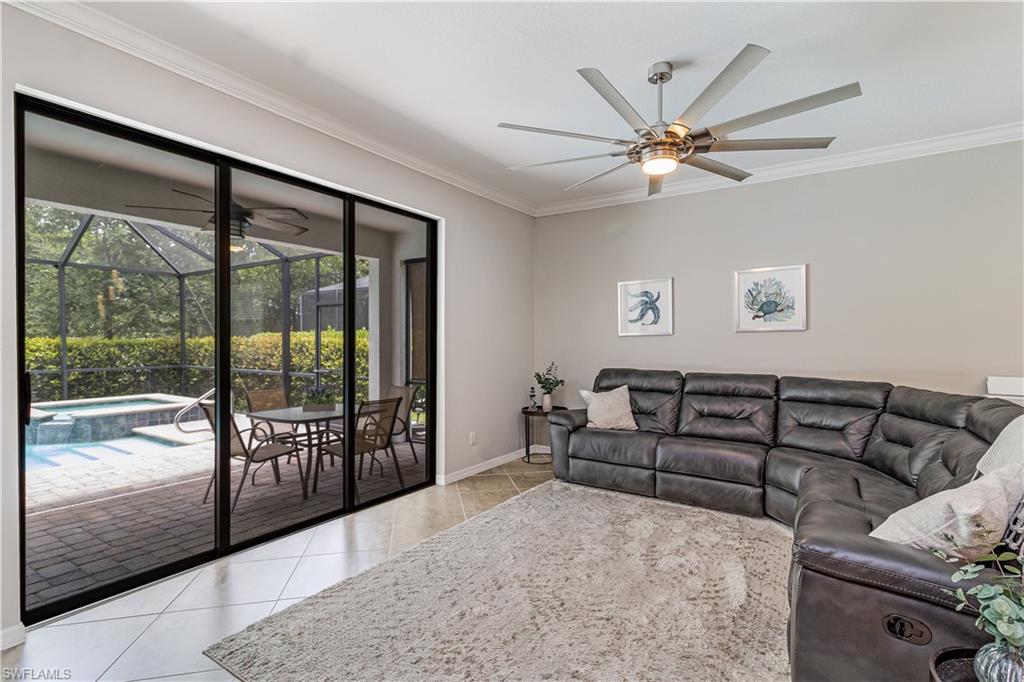 4272 Raffia Palm Circle Naples, FL 34119 - Photo 9 of 41 Living room featuring ceiling fan, ornamental molding, and light tile patterned floors