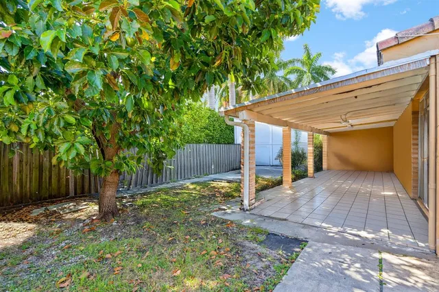 a view of backyard of house with green space