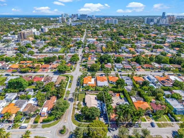an aerial view of residential houses with city view and parking