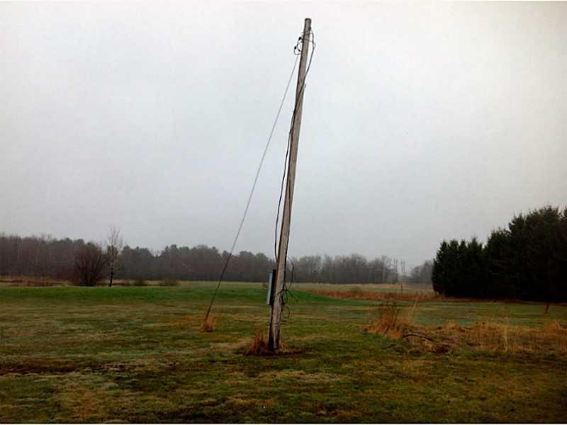 598 Brewer Lake Road Orrington, ME 04474 - Photo 8 of 12 Exterior Front. power pole on site