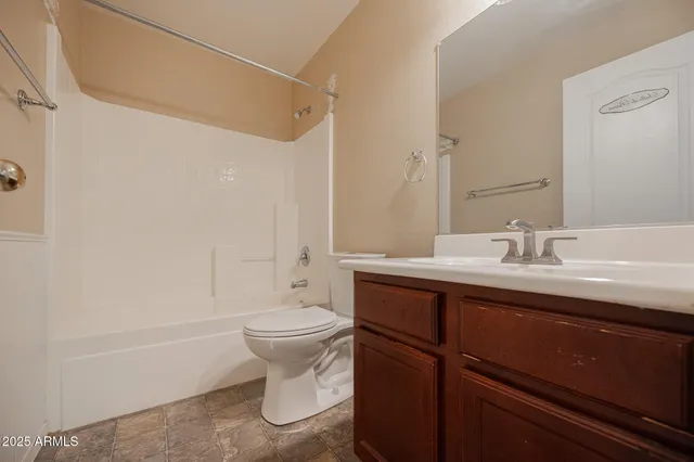 a bathroom with a sink toilet a mirror and shower
