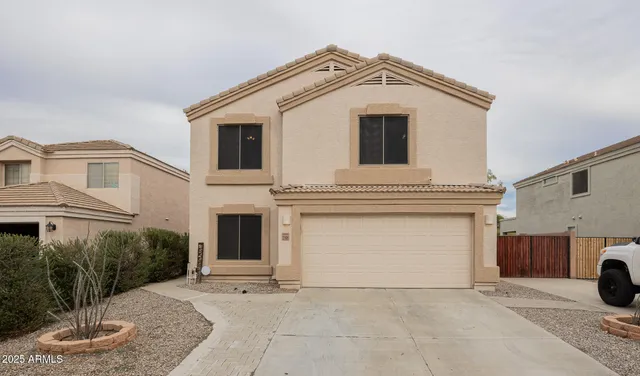 a view of a white house with large windows