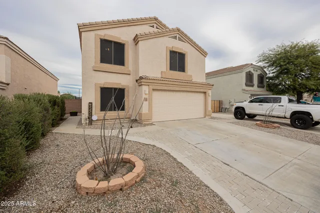 a house with yard and a car parked in front of it