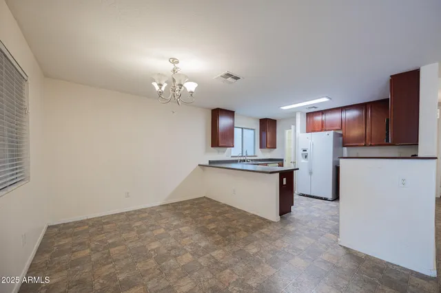 a large kitchen with cabinets and stainless steel appliances