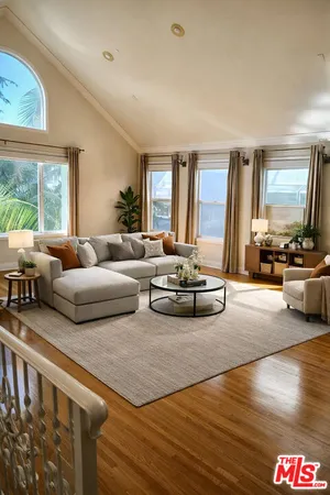 a living room with furniture and large windows